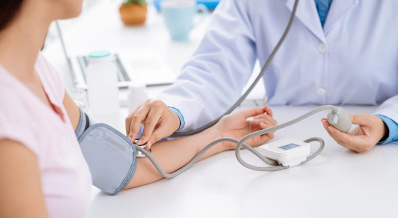 Doctor checking blood pressure of the patient Doctor checking blood pressure of the patient