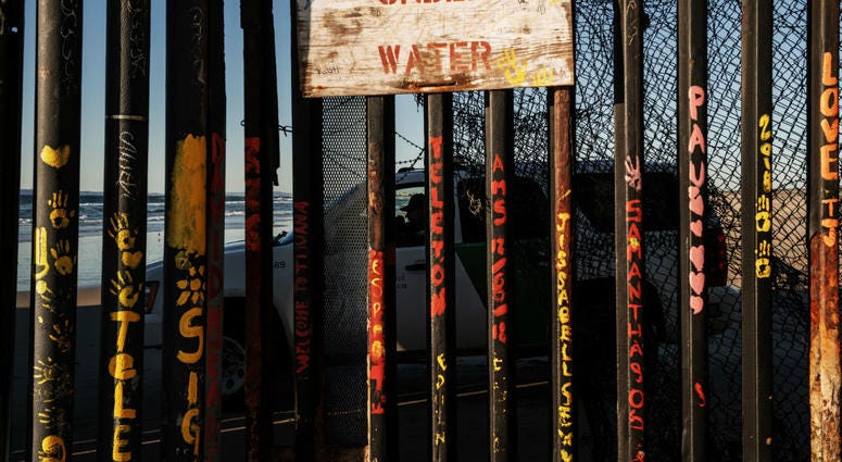 In this Jan. 2, 2019, photo, a border patrol officer inside his vehicle guards the border fence at the U.S. side of San Diego, Calif., as seen from Tijuana, Mexico. In this Jan. 2, 2019, photo, a border patrol officer inside his vehicle guards the border fence at the U.S. side of San Diego, Calif., as seen from Tijuana, Mexico.