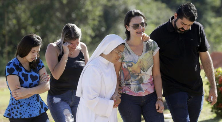 Friends and relatives attend the burial of Vale SA employee Edgar Carvalho Santos, victim of the collapsed dam in Brumadinho, Brazil, Tuesday, Jan. 29, 2019. Friends and relatives attend the burial of Vale SA employee Edgar Carvalho Santos, victim of the collapsed dam in Brumadinho, Brazil, Tuesday, Jan. 29, 2019.