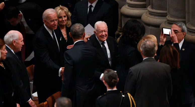 Former President Jimmy Carter and former Vice President Joe Biden arrive at a state funeral for former President George H.W. Bush at the Washington National Cathedral, in Washington, Dec. 5, 2018. Former President Jimmy Carter and former Vice President Joe Biden arrive at a state funeral for former President George H.W. Bush at the Washington National Cathedral, in Washington, Dec. 5, 2018.