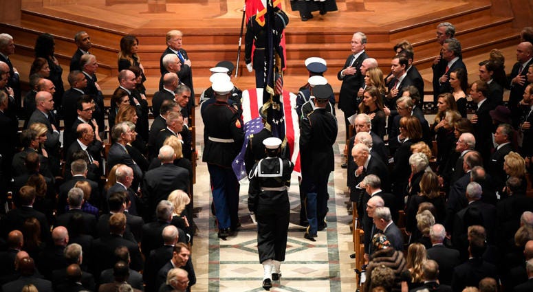 The flag-draped casket of former President George H.W. Bush is carried by a military honor guard during a State Funeral at the National Cathedral, Wednesday, Dec. 5, 2018, in Washington. The flag-draped casket of former President George H.W. Bush is carried by a military honor guard during a State Funeral at the National Cathedral, Wednesday, Dec. 5, 2018, in Washington.