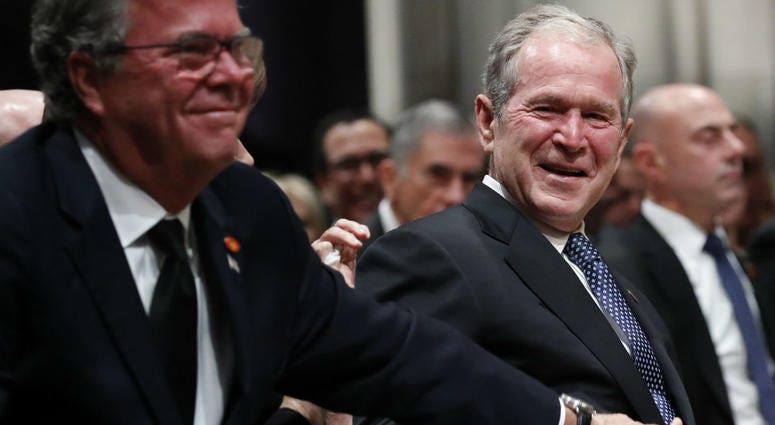Former President George W. Bush smiles with his brother Jeb Bush at the state funeral for their father, former President George H.W. Bush, at the Washington National Cathedral on December 5, 2018 in Washington, DC. Former President George W. Bush smiles with his brother Jeb Bush at the state funeral for their father, former President George H.W. Bush, at the Washington National Cathedral on December 5, 2018 in Washington, DC.