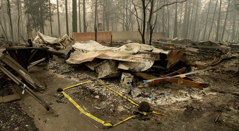 Tape marks a spot where sheriff's deputies recovered the body of a Camp Fire victim on Wednesday, Nov. 14, 2018, in Paradise, Calif. Tape marks a spot where sheriff's deputies recovered the body of a Camp Fire victim on Wednesday, Nov. 14, 2018, in Paradise, Calif.