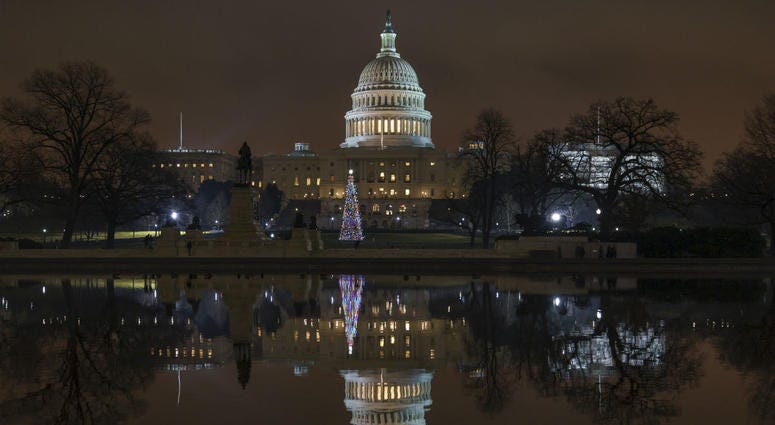 The Capitol is mirrored in the Reflecting Pool in Washington, as a partial government shutdown heads into a second week, Friday night, Dec. 28, 2018. The Capitol is mirrored in the Reflecting Pool in Washington, as a partial government shutdown heads into a second week, Friday night, Dec. 28, 2018.