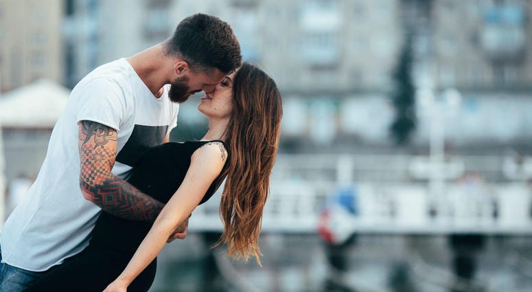 Couple kissing against the backdrop of the city Couple kissing against the backdrop of the city