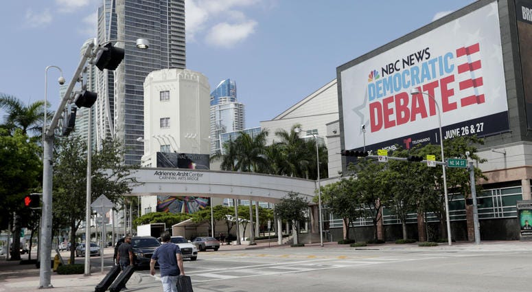 In this June 24, 2019, photo, a billboard advertises the Democratic Presidential Debates across from the Knight Concert Hall at the Adrienne Arsht Center for the Performing Arts of Miami-Dade County, in Miami. In this June 24, 2019, photo, a billboard advertises the Democratic Presidential Debates across from the Knight Concert Hall at the Adrienne Arsht Center for the Performing Arts of Miami-Dade County, in Miami.