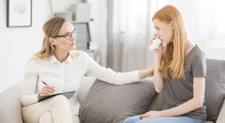 Female psychologist comforting teenage girl with anxiety disorder anxiety
