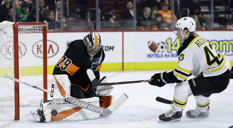 Philadelphia Flyers' Carter Hart, left, blocks a shot by Boston Bruins' Danton Heinen during the first period of an NHL hockey game, Wednesday, Jan. 16, 2019, in Philadelphia. Philadelphia Flyers' Carter Hart, left, blocks a shot by Boston Bruins' Danton Heinen during the first period of an NHL hockey game, Wednesday, Jan. 16, 2019, in Philadelphia.