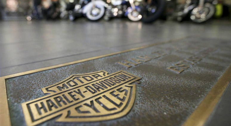 In this April 26, 2017, file photo, rows of motorcycles are behind a bronze plate with corporate information on the showroom floor at a Harley-Davidson dealership in Glenshaw, Pa. In this April 26, 2017, file photo, rows of motorcycles are behind a bronze plate with corporate information on the showroom floor at a Harley-Davidson dealership in Glenshaw, Pa.