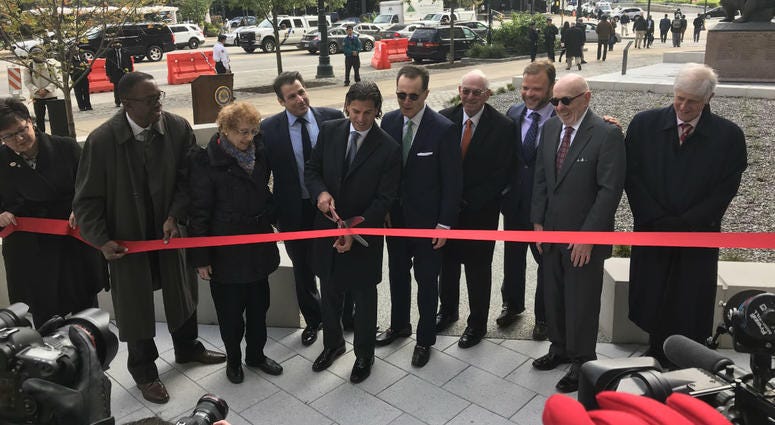 David Adelman, center, with the Philadelphia Holocaust Remembrance Foundation, cuts the ribbon at the Holocaust Remembrance Foundation opening ceremony. David Adelman, center, with the Philadelphia Holocaust Remembrance Foundation, cuts the ribbon at the Holocaust Remembrance Foundation opening ceremony.