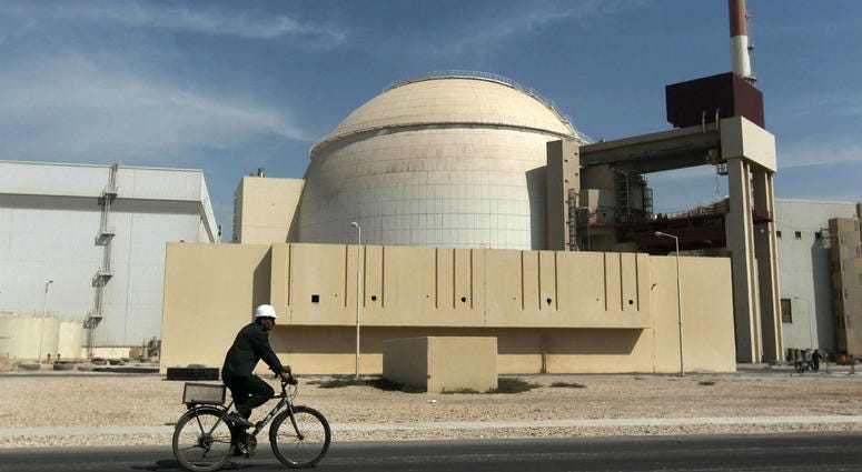 In this Oct. 26, 2010 file photograph, a worker rides a bicycle in front of the reactor building of the Bushehr nuclear power plant, just outside the southern city of Bushehr. In this Oct. 26, 2010 file photograph, a worker rides a bicycle in front of the reactor building of the Bushehr nuclear power plant, just outside the southern city of Bushehr.
