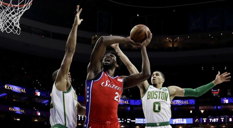 Philadelphia 76ers' Joel Embiid, center, goes up for a shot between Boston Celtics' Al Horford, left, and Jayson Tatum during the first half of an NBA basketball game, Tuesday, Feb. 12, 2019, in Philadelphia. Philadelphia 76ers' Joel Embiid, center, goes up for a shot between Boston Celtics' Al Horford, left, and Jayson Tatum during the first half of an NBA basketball game, Tuesday, Feb. 12, 2019, in Philadelphia.