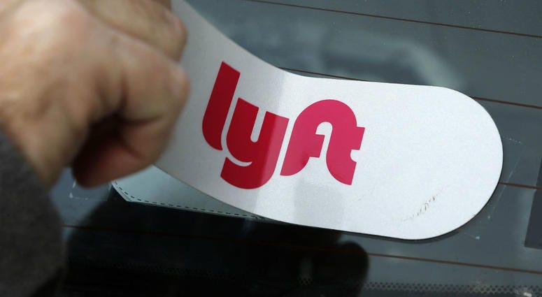 Lyft has set a price range for its initial public offering, which could value the company at about $20 billion. Lyft sticker applied to the rear window so a car