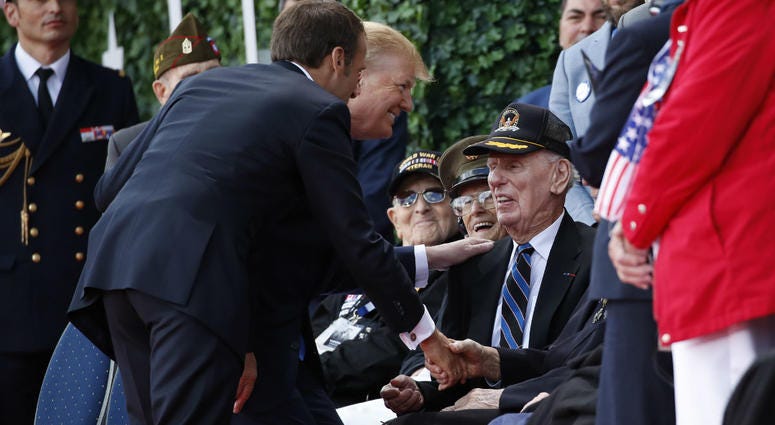 President Donald Trump and French President Emmanuel Macron greet veterans as they arrive to a ceremony to commemorate the 75th anniversary of D-Day at The Normandy American Cemetery, Thursday, June 6, 2019, in Colleville-sur-Mer, Normandy, France. President Donald Trump and French President Emmanuel Macron greet veterans as they arrive to a ceremony to commemorate the 75th anniversary of D-Day at The Normandy American Cemetery, Thursday, June 6, 2019, in Colleville-sur-Mer, Normandy, France.