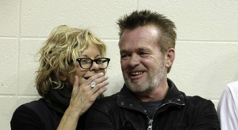 In this Dec. 31, 2011 file photo, Actress Meg Ryan, left, talks with performer John Mellencamp during the second half of an NCAA college basketball game between Indiana and Ohio State in Bloomington, Ind. In this Dec. 31, 2011 file photo, Actress Meg Ryan, left, talks with performer John Mellencamp during the second half of an NCAA college basketball game between Indiana and Ohio State in Bloomington, Ind.