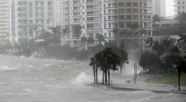 This Sept. 10, 2017 file photo shows waves crashing over a seawall at the mouth of the Miami River from Biscayne Bay, Fla., as storm surge from Hurricane Irma impacts Miami. Hurricane Irma hits Miami