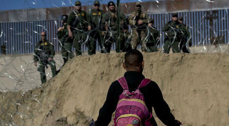 A Honduran migrant converses with U.S border agents on the other side of razor wire after they fired tear gas at migrants pressuring to cross into the U.S. from Tijuana, Mexico, Sunday, Nov. 25, 2018. A Honduran migrant converses with U.S border agents on the other side of razor wire after they fired tear gas at migrants pressuring to cross into the U.S. from Tijuana, Mexico, Sunday, Nov. 25, 2018.
