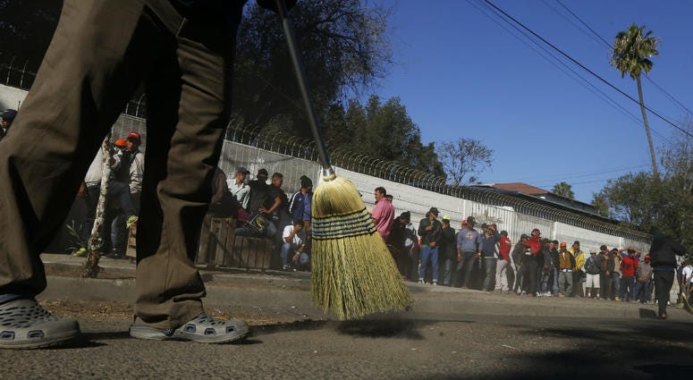 Central American migrants sweep outside the shelter where they are staying in Tijuana, Mexico, Sunday, Nov. 18, 2018. Central American migrants sweep outside the shelter where they are staying in Tijuana, Mexico, Sunday, Nov. 18, 2018.