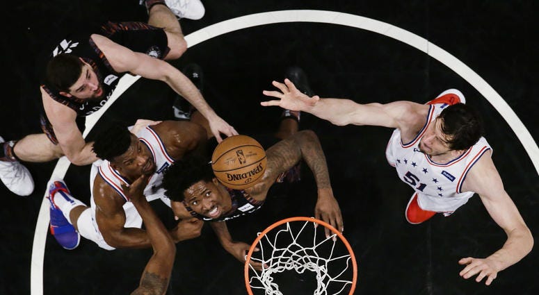 Philadelphia 76ers' Boban Marjanovic, right, shoots over Brooklyn Nets' Ed Davis, center, during the first half in Game 3 of a first-round NBA basketball playoff series Thursday, April 18, 2019, in New York. The 76ers won 131-115. Philadelphia 76ers' Boban Marjanovic, right, shoots over Brooklyn Nets' Ed Davis, center, during the first half in Game 3 of a first-round NBA basketball playoff series Thursday, April 18, 2019, in New York. The 76ers won 131-115.