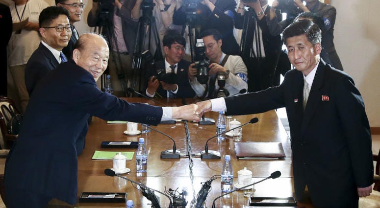 In this photo provided by South Korea Unification Ministry, South Korean Red Cross President Park Kyung-seo, second from left, shakes hands with his North Korean counterpart Pak Yong Il. In this photo provided by South Korea Unification Ministry, South Korean Red Cross President Park Kyung-seo, second from left, shakes hands with his North Korean counterpart Pak Yong Il.