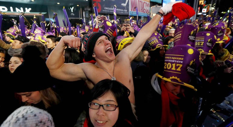 In this Dec. 31, 2016 file photo, Andrew Dickens, 21, of Toledo, Ohio, stands with other revelers during the New Year's Eve celebration in New York's Times Square. In this Dec. 31, 2016 file photo, Andrew Dickens, 21, of Toledo, Ohio, stands with other revelers during the New Year's Eve celebration in New York's Times Square.