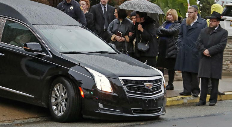 Mourners watch as the hearse carrying the casket of Richard Gottfried leaves the Ralph Schugar Funeral home in Pittsburgh following a memorial service Nov. 1, 2018. Mourners watch as the hearse carrying the casket of Richard Gottfried leaves the Ralph Schugar Funeral home in Pittsburgh following a memorial service Nov. 1, 2018.