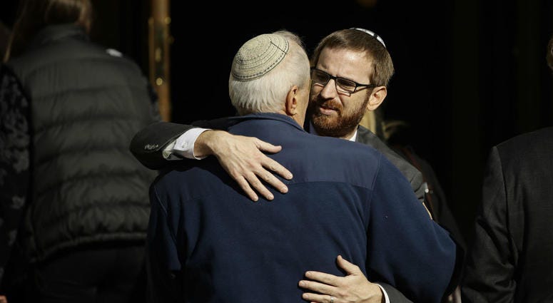 Mourners hug outside Rodef Shalom Congregation during the funeral services for brothers Cecil and David Rosenthal, Tuesday, Oct. 30, 2018, in Pittsburgh. Mourners hug outside Rodef Shalom Congregation during the funeral services for brothers Cecil and David Rosenthal, Tuesday, Oct. 30, 2018, in Pittsburgh.