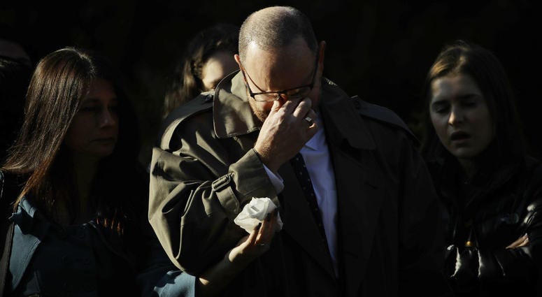 A mourner reacts outside Rodef Shalom Congregation before the funeral services for brothers Cecil and David Rosenthal, Tuesday, Oct. 30, 2018, in Pittsburgh. A mourner reacts outside Rodef Shalom Congregation before the funeral services for brothers Cecil and David Rosenthal, Tuesday, Oct. 30, 2018, in Pittsburgh.
