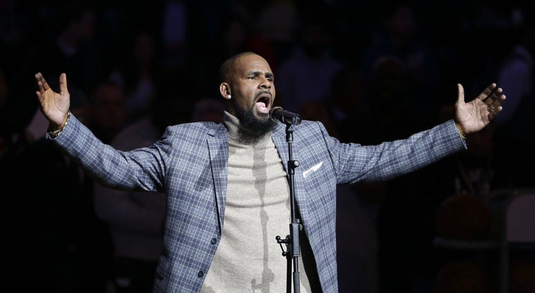 In this Nov. 17, 2015, file photo, musical artist R. Kelly performs the national anthem before an NBA basketball game between the Brooklyn Nets and the Atlanta Hawks in New York. musical artist R. Kelly