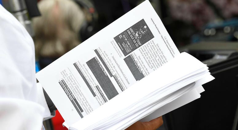Television networks print out and read the released Mueller Report on the sidewalk outside of the Department of Justice. Television networks print out and read the released Mueller Report on the sidewalk outside of the Department of Justice.