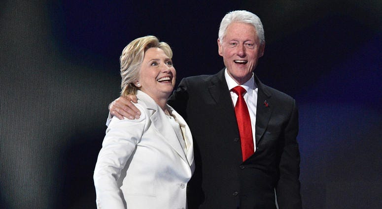 Former President Bill Clinton embraces his wife Hillary Clinton, then-Democratic presidential nominee, on the fourth and final day of the 2016 Democratic National Convention at the Wells Fargo Center in Philadelphia, on July 28, 2016. Hillary and Bill Clinton