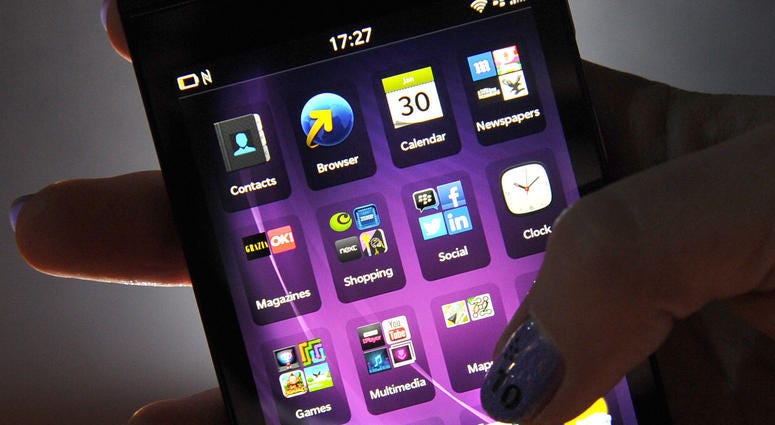 Someone holding a BlackBerry touchscreen device. Someone holding a BlackBerry touchscreen device.