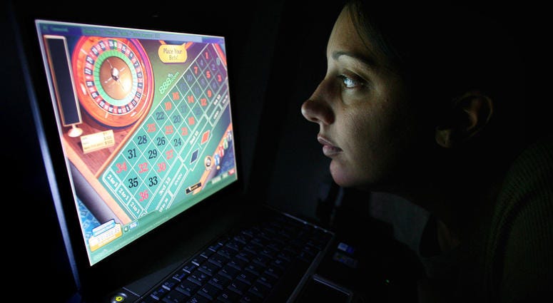 A woman using an internet gambling website to play online roulette. A woman using an internet gambling website to play online roulette.