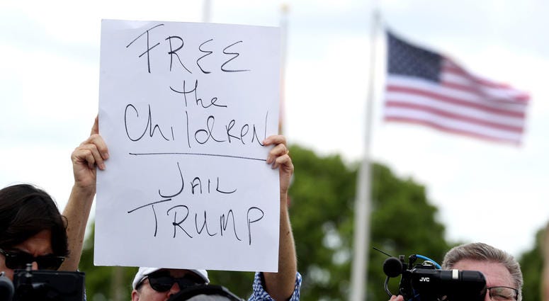 Protester Melissa Houtte holds her sign while Sen. Bill Nelson and Congresswoman Debbie Wasserman Schultz address the media after being denied access to visit the Homestead Temporary Shelter for Unaccompanied Children on June 19, 2018 in Homestead, Fla. Protester Melissa Houtte holds her sign while Sen. Bill Nelson and Congresswoman Debbie Wasserman Schultz address the media after being denied access to visit the Homestead Temporary Shelter for Unaccompanied Children on June 19, 2018 in Homestead, Fla.