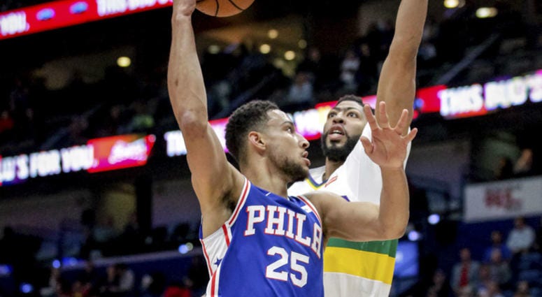 Philadelphia 76ers guard Ben Simmons (25) shoots against New Orleans Pelicans forward Anthony Davis (23) in the first half of an NBA basketball game in New Orleans, Monday, Feb. 25, 2019. Philadelphia 76ers guard Ben Simmons (25) shoots against New Orleans Pelicans forward Anthony Davis (23) in the first half of an NBA basketball game in New Orleans, Monday, Feb. 25, 2019.
