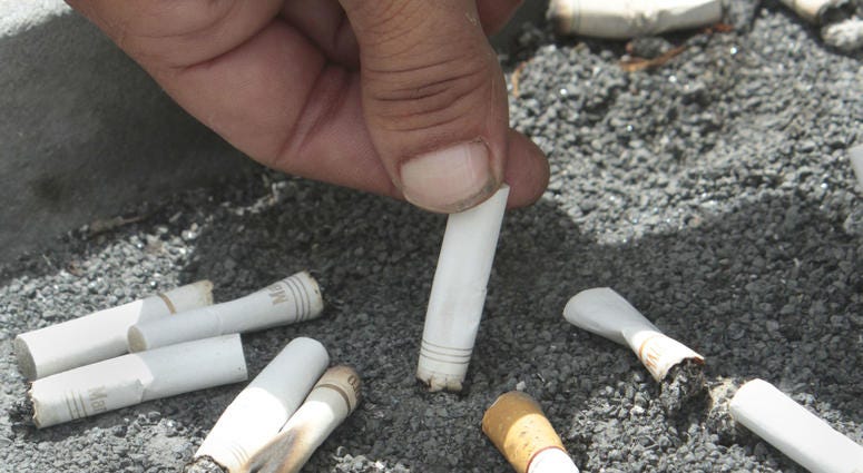 In this June 22, 2012, file photo, a smoker snuffs out a cigarette at the Capitol in Sacramento, Calif. In this June 22, 2012, file photo, a smoker snuffs out a cigarette at the Capitol in Sacramento, Calif.
