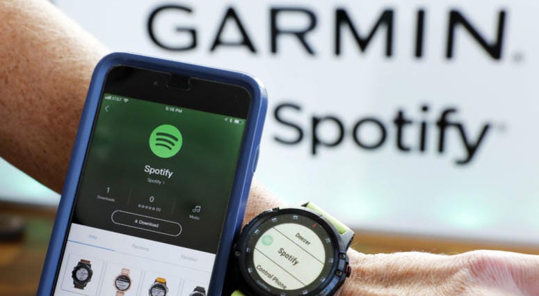 In this Oct. 3, 2018, file photo a Garmin International employee shows the new Spotify app on his smartphone integrated with his Garmin fenix 5 Plus watch during a presentation in New York. Spotify reports financial results Wednesday, Feb. 6, 2019. In this Oct. 3, 2018, file photo a Garmin International employee shows the new Spotify app on his smartphone integrated with his Garmin fenix 5 Plus watch during a presentation in New York. Spotify reports financial results Wednesday, Feb. 6, 2019.