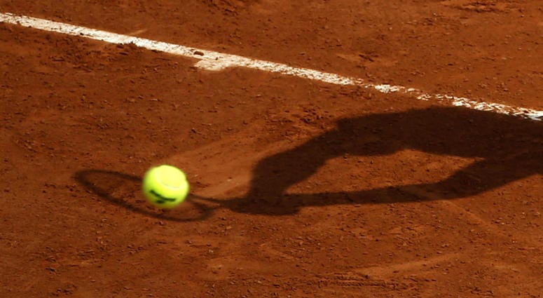 In this May 28, 2016 file photo, a player's shadow is pictured as he returns the ball during the French Open tennis tournament at the Roland Garros stadium, in Paris. In this May 28, 2016 file photo, a player's shadow is pictured as he returns the ball during the French Open tennis tournament at the Roland Garros stadium, in Paris.