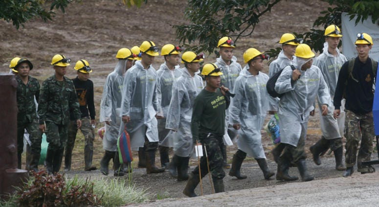 Rescuers walk toward the entrance to a cave complex where five were still trapped, in Mae Sai, Chiang Rai province, northern Thailand Tuesday, July 10, 2018. The eight boys were rescued from the flooded cave. Rescuers walk toward the entrance to a cave complex where five were still trapped, in Mae Sai, Chiang Rai province, northern Thailand Tuesday, July 10, 2018. The eight boys were rescued from the flooded cave.