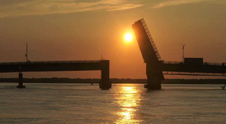 Townsend’s Inlet Bridge between Avalon and Sea Isle City, New Jersey at sunset with the drawbridge up for boats to pass below. Townsend’s Inlet Bridge between Avalon and Sea Isle City, New Jersey at sunset with the drawbridge up for boats to pass below.