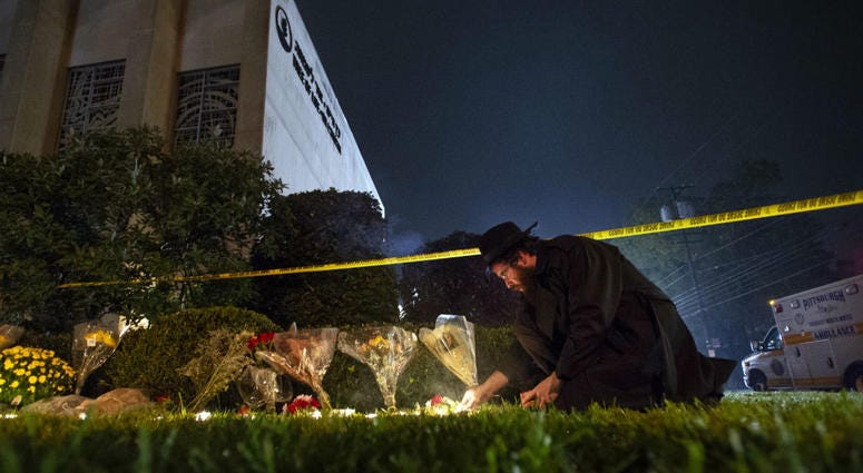 In this Oct. 27, 2018 photo, Rabbi Eli Wilansky lights a candle after a mass shooting at Tree of Life Synagogue in Pittsburgh's Squirrel Hill neighborhood. In this Oct. 27, 2018 photo, Rabbi Eli Wilansky lights a candle after a mass shooting at Tree of Life Synagogue in Pittsburgh's Squirrel Hill neighborhood.