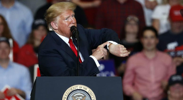 President Donald Trump looks at his watch near the end of a campaign rally Monday, Nov. 5, 2018, in Cape Girardeau, Mo. President Donald Trump looks at his watch near the end of a campaign rally Monday, Nov. 5, 2018, in Cape Girardeau, Mo.
