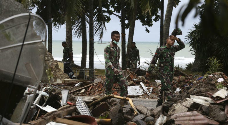 Indonesia soldier walks near debris at a tsunami-ravaged area in Carita, Indonesia, Wednesday, Dec. 26, 2018. Indonesia soldier walks near debris at a tsunami-ravaged area in Carita, Indonesia, Wednesday, Dec. 26, 2018.