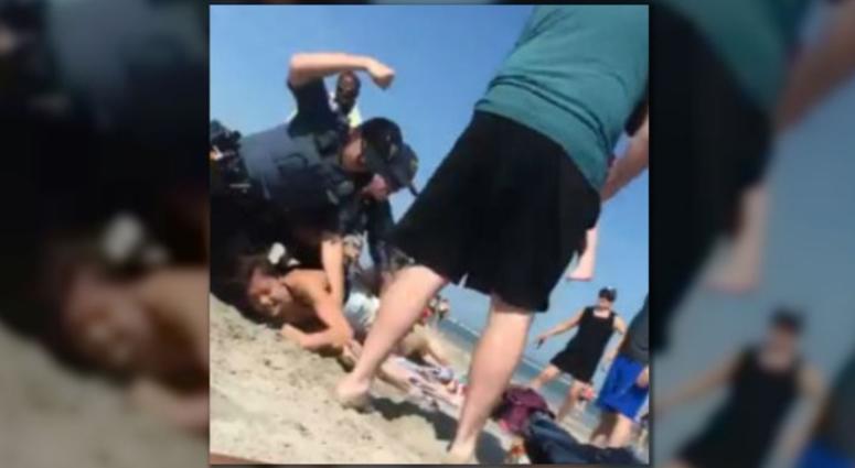 An investigation is underway after video shows a New Jersey police officer striking a woman several times during a beach arrest. An investigation is underway after video shows a New Jersey police officer striking a woman several times during a beach arrest.