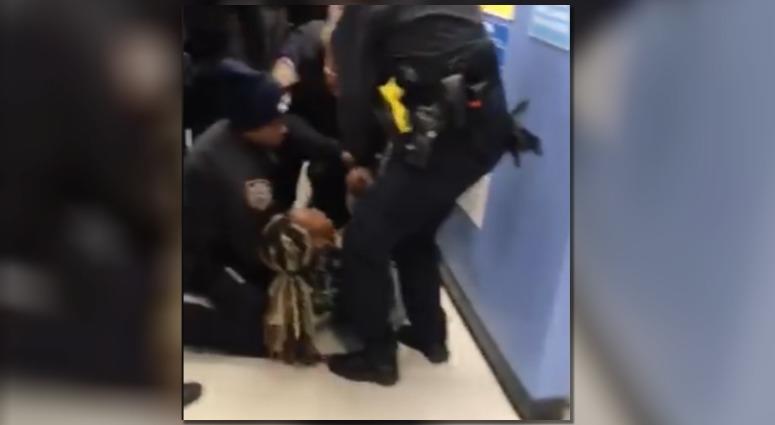 The chaotic, two-minute video shows police wrestling with Jazmine Headley as people scream in the background. The chaotic, two-minute video shows police wrestling with Jazmine Headley as people scream in the background.