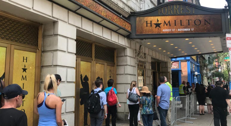 People line up outside the Forrest Theatre July 9, 2019 for the chance to buy tickets to the touring production of "Hamilton" in Philadelphia. Hamilton