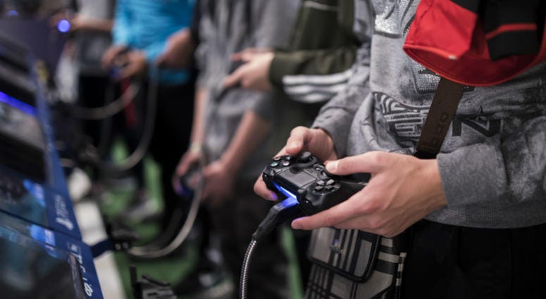 In this Friday, Nov. 3, 2017 file photo, a man plays a game at the Paris Games Week in Paris. In this Friday, Nov. 3, 2017 file photo, a man plays a game at the Paris Games Week in Paris.