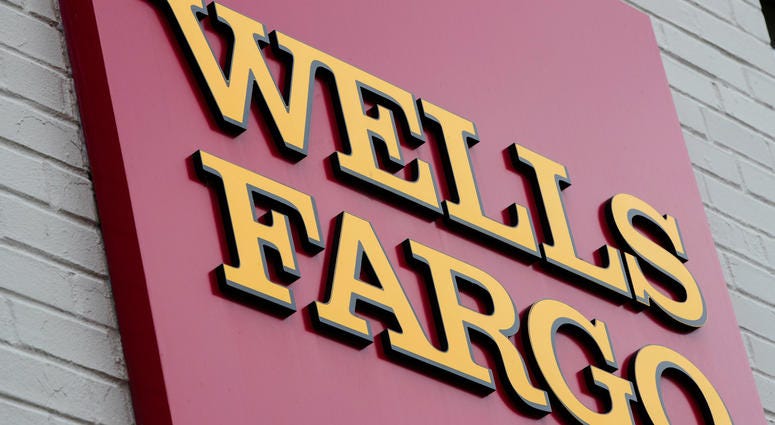 FILE - This Aug. 11, 2017, file photo shows a sign at a Wells Fargo bank location in Philadelphia. Wells Fargo bank location in Philadelphia.