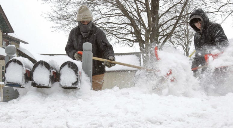 Ausencio Castaneda of Kewaskum, left, clears a path to a series of mailboxes outside a multi-family home with his son Ausencio Castaneda Jr. onMonday, Jan. 28, 2019, in Kewaskum, Wis. Ausencio Castaneda of Kewaskum, left, clears a path to a series of mailboxes outside a multi-family home with his son Ausencio Castaneda Jr. onMonday, Jan. 28, 2019, in Kewaskum, Wis.