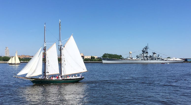 The battleship USS New Jersey, seen in the background, fired off rounds during the Parade of Sail. The battleship USS New Jersey, seen in the background, fired off rounds during the Parade of Sail.